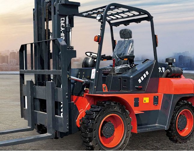 Red and black forklift parked outdoors