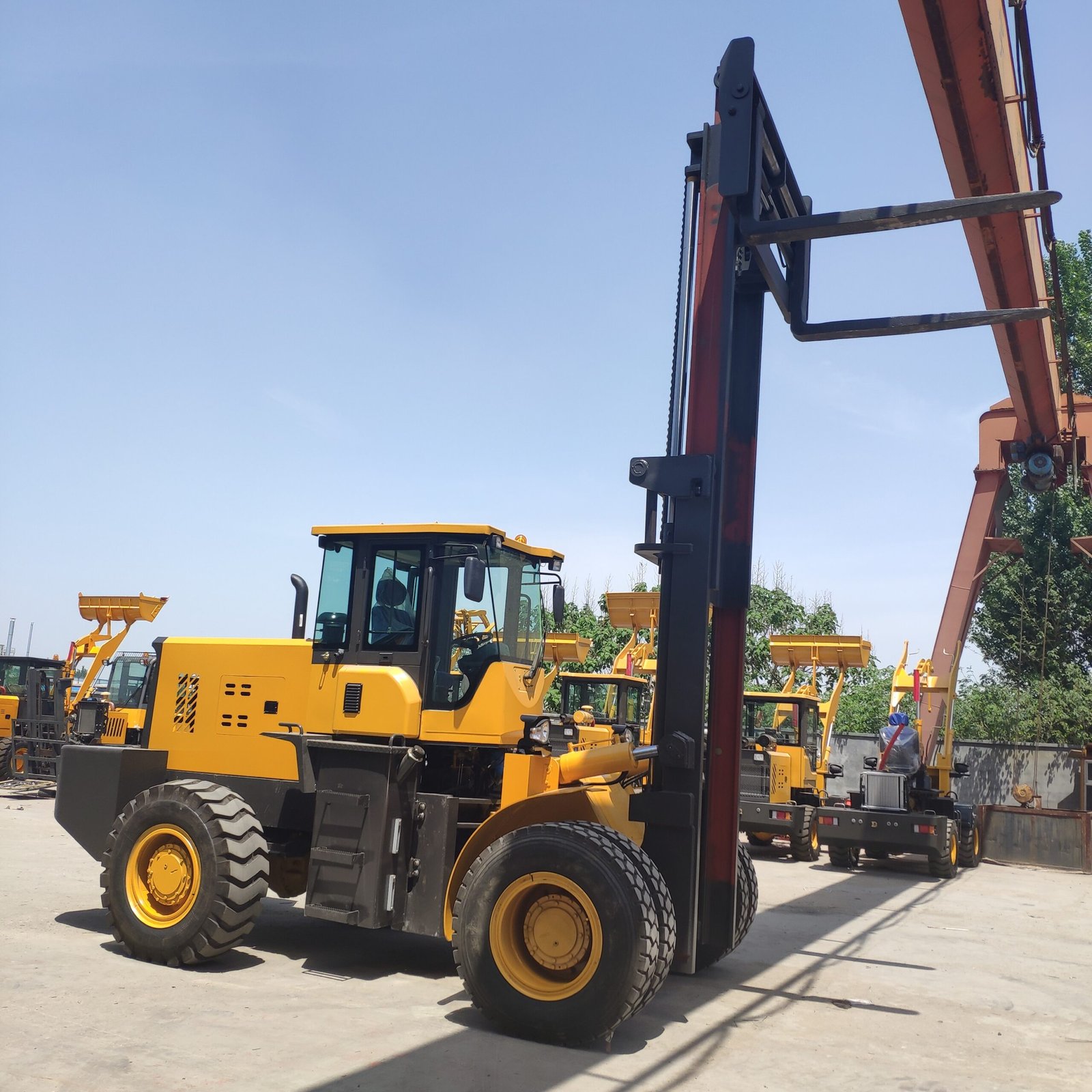 Yellow forklift in industrial equipment yard