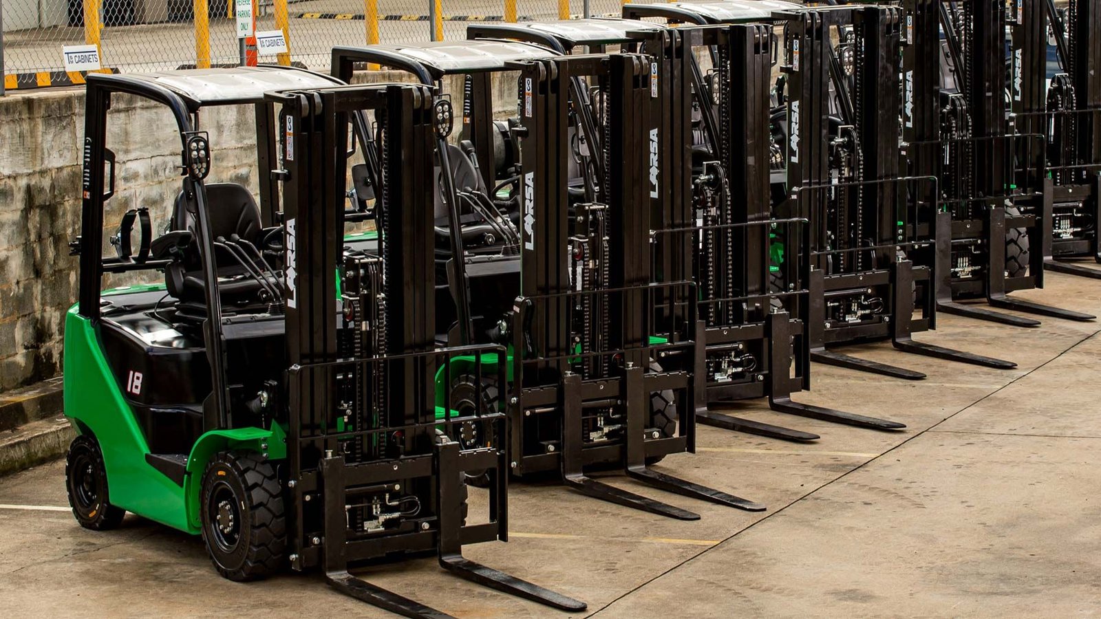 Row of new forklifts in warehouse