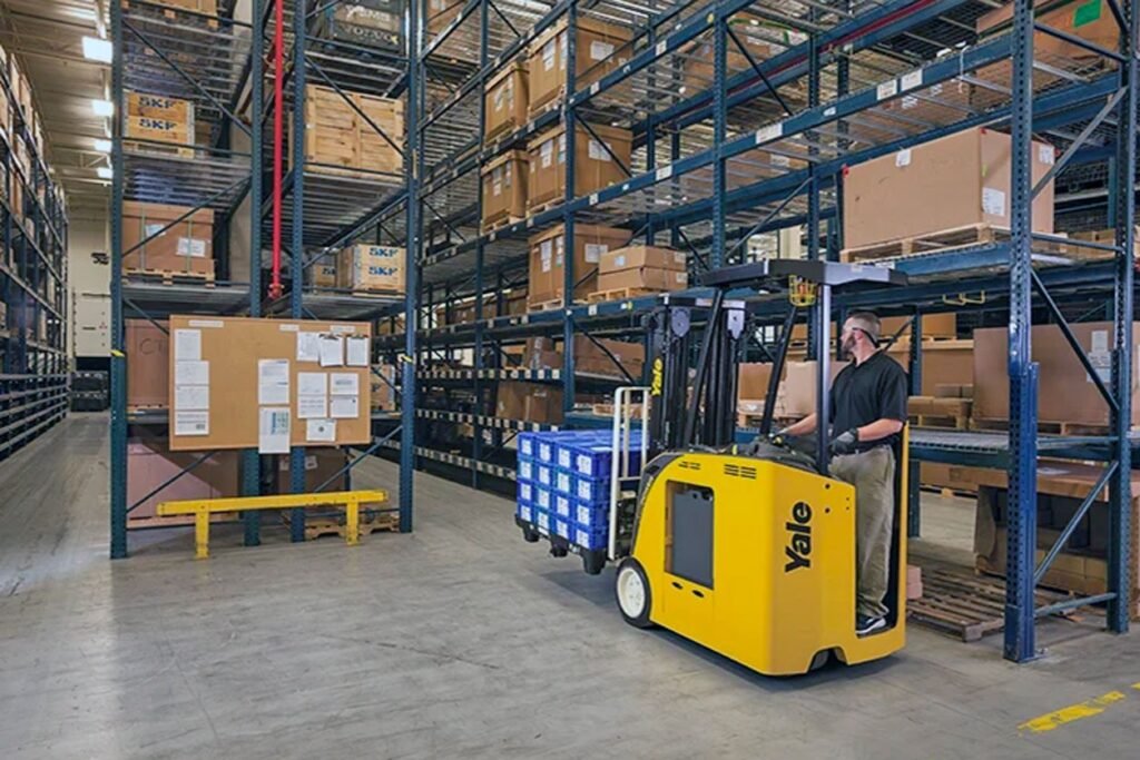 Worker operating forklift in organized warehouse