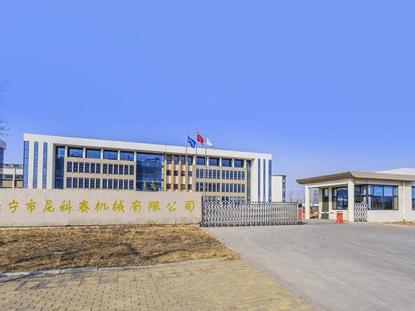 Modern school building with flags under clear blue sky