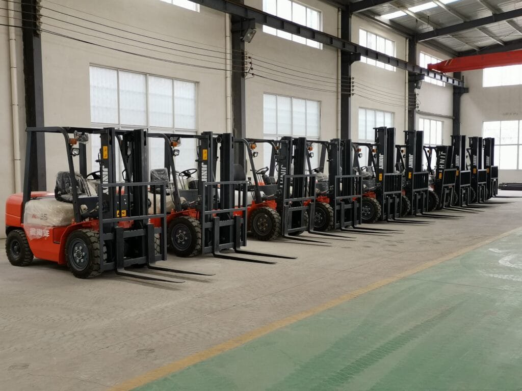 Row of new forklifts in industrial warehouse